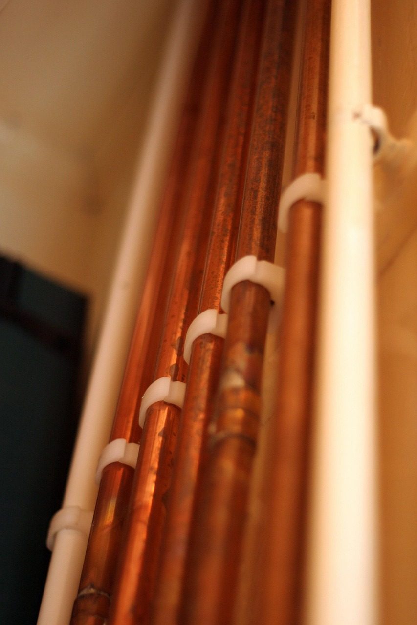 Copper pipework freshly installed along a wall